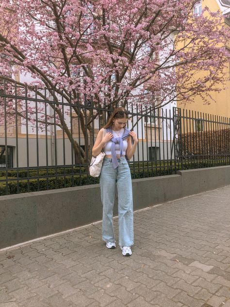 A trendy and cute outfit for spring! Big pants, little shirt with a lavender sweater and white New Balance sneakers. The light jeans matches perfectly with the pastel color of the sweater. Trendy spring outfits | spring outfits 2021 | spring trends 2021 Sweater White Shirt Outfit, Lavender Sweater Vest Outfit, Lavender Sweater Aesthetic, Trendy Lavender Fall Sweater, White New Balance Sneakers, Lavender Graphic Tee, Lavender Crew Neck T-shirt For Streetwear, White New Balance, Lavender Sweater