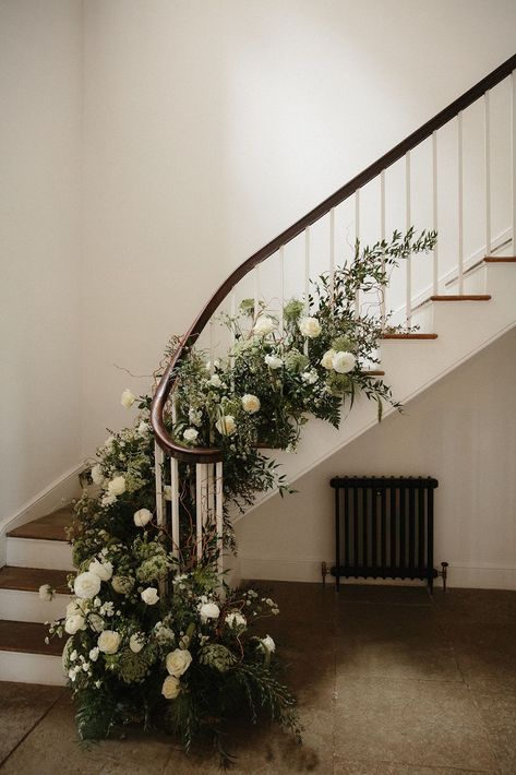 Stairs decorated with green and white wedding flowers. Aswarby Rectory wedding venue, Lincoln. Photography by Lincoln Pictures. Wedding Flowers On Stairs, Stair Florals Wedding, Flowers Down Stairs Wedding, Wedding Stairs Flowers, Stair Flowers Wedding, Flowers On Stairs Wedding, Stairs Decor Wedding, Aswarby Rectory Wedding, Staircase Wedding Flowers