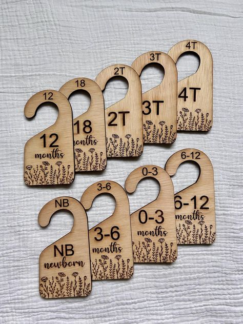 These wooden closet dividers are perfect for organizing your baby's clothes by size. The set includes eight dividers that are designed to fit most standard closet rods. The dividers are laser-engraved with sizes ranging from newborn to 12 months and 18 months to 4T, making it easy to find the right size for your little one's clothes. The adorable dividers are simple, yet sturdy and make a great addition to any nursery decor. These dividers also make a great baby shower gift for new parents. - Ma Baby Clothing Storage, Nursery Closet Dividers, Baby Clothes Storage, Baby Closet Dividers, Wooden Closet, Closet Rods, Closet Dividers, Nursery Closet, Newborn Clothes