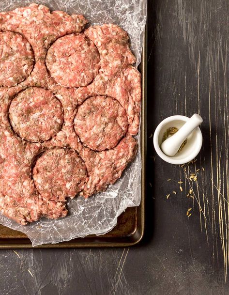 raw sausage flattened into an even layer being cut into round sausage patties. mini mortar and pestal on the side to season the breakfast sausage recipe with fennel seed Make Breakfast Sausage, Breakfast Sausage Recipe, Breakfast Sausage Seasoning, Sausage Making Recipes, Chicken Sausage Recipes, Pork Sausage Recipes, Pork Breakfast Sausage, Homemade Breakfast Sausage, Sausage Ingredients