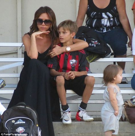 Game girl: Victoria hugged one of her boys while she enjoyed the exciting action on the pitch Beckham Football, Soccer Games For Kids, Harper Beckham, Romeo Beckham, Beckham Style, Victoria And David, Football Wags, David And Victoria Beckham, Victoria Beckham Style