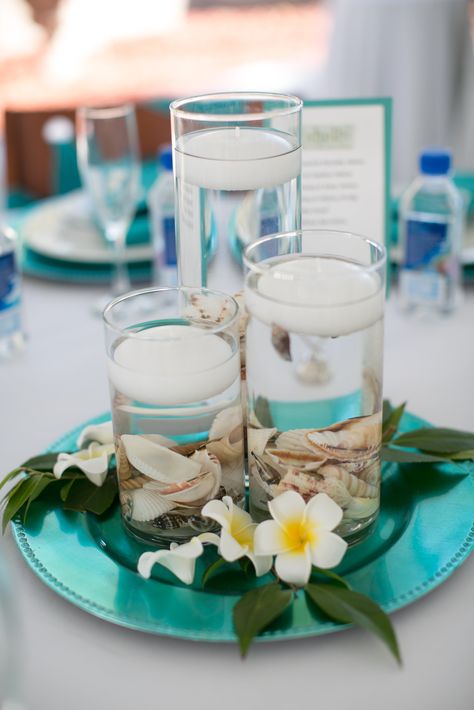 Water Theme Table Decor, Hawaiian Themed Table Decor, Frangipani Table Decorations, Carribean Centerpiece Ideas, Luau Table Setting, Simple Tropical Centerpieces, Hawaiian Table Decorations, Candles In Vases, 60th Wedding Anniversary Decorations