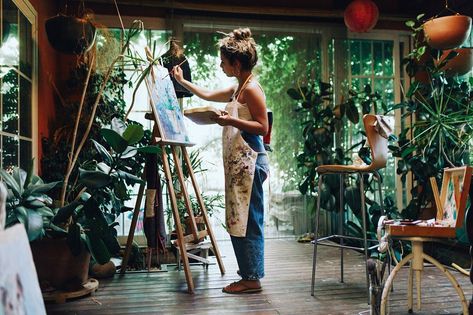 Indoor shot of professional female artist painting on canvas in studio with plants. Artist Painting On Canvas, Studio With Plants, Female Artists Painting, Art Studio Space, Art Studio Room, Art Studio Design, Painter Painting, Art Studio At Home, Female Artist