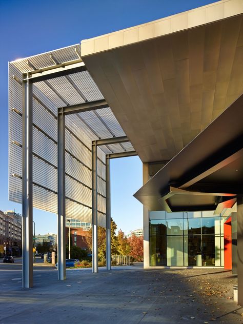 The signature feature of the new addition is an entry canopy that soars 34 feet above the pavement, joining the new addition to the existing building, designed by Antoine Predock. The canopy, which creates an outdoor gathering spot, was made with aluminum grating and stainless-steel panels fashioned from portions of the existing building that were demolished to make way for the new gallery space. Photo 2 of 8 in New Olson Kundig-Designed Wing Opens at Tacoma Art Museum Olson Kundig, Canopy Architecture, Metal Facade, Backyard Canopy, Warehouse Design, Outdoor Gathering, Porte Cochere, Garden Canopy, Steel Canopy