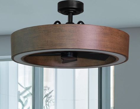 The 26-in Vanderbrook in black and walnut finish combines the style of a ceiling light along with the functionality of a ceiling fan making it a great option for your lighting and cooling needs. The Vanderbrook is equipped with a 6-speed remote control so you can maintain your ideal comfort level and a reversible motor function which allows you to change the direction of your fan from downdraft mode during the summer to updraft mode during the winter. The fan's integrated LED light kit is fully 1950 Lighting Fixtures, Office With Led Lights, Fan Above Dining Table, Hidden Fan Light Fixture, Ceiling Fan In Kitchen Ideas, Industrial Farmhouse Light Fixtures, Harbor Breeze Ceiling Fan, Masculine Bedroom Lighting, Living Room Fan Ideas