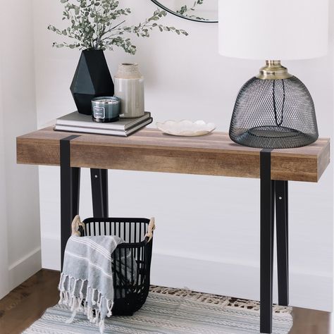 This modern farmhouse-inspired console table brings character to your living room or den. Its rectangular design is crafted from high quality manufactured wood with a beautiful oak finish and is made to last for years to come. Entry Table With Black Metal Legs, Black Metal Entry Table, Black Metal Entryway Table, Black Entry Table Decor, Black Rattan Entry Table, Wood And Black Metal Console Table, Entryway Decor Modern, Small Den, Canada Decor