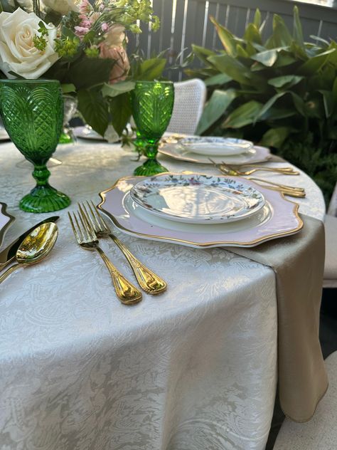 Our Carousel Goblet in Fern Green— Its lush green hue brings the vibrancy of nature to your event. Titan Savoy flatware set in gold. The golden accents lend a regal touch to the table, ensuring that every moment of your dining experience exudes opulence and grace.⁠ ⁠The Tara Coup Dinner Plate- its floral design is timeless allowing its versatility to be worked into many setting styles. Trieste gold charger- its gold finish is a symbol of celebration and luxury, reflecting the timeless beauty Kate Spade Cake, Silver Chiavari Chairs, Silver Cake Stand, Silver Side Table, Glass Beverage Dispenser, Gold Cake Stand, Chair Rentals, Gold Chargers, Silver Cake