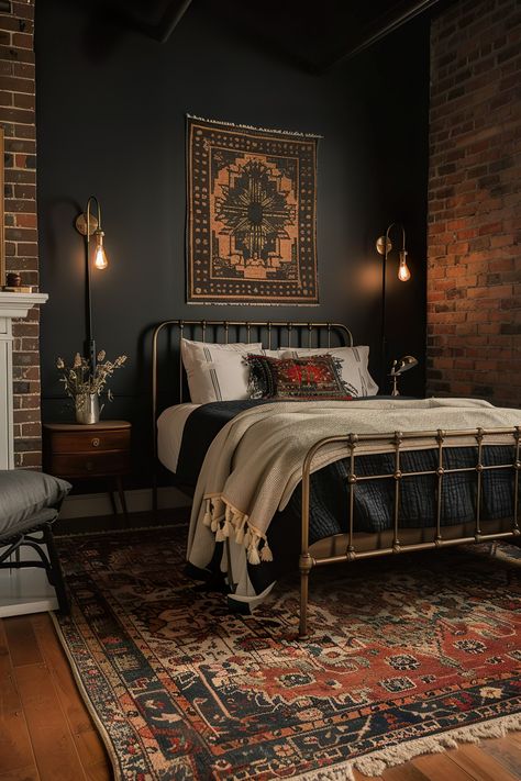 Modern bedroom with a dark accent wall behind the bed, industrial lamps, vintage rug, metal bed frame, and brick elements for a cozy, eclectic look. All Black Bedding Bedroom Ideas, Black Attic Bedroom, Accent Black Wall Bedroom, Black Wall Bedroom Aesthetic, Dark Color Drenched Bedroom, Black Brick Accent Wall, Eclectic Moody Bedroom, Dark And Moody Bedroom Ideas, Light Moody Bedroom