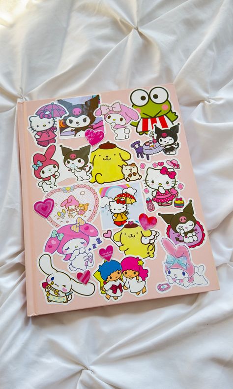 Light pink hardcover sketchbook with Hello Kitty stickers covering the front. Notebook Stickers Aesthetic, Stickers On Notebook, Sketchbook Stickers, Money Wallpaper Iphone, Pink Notebook, Sketchbook Cover, Pretty Journals, Notebook Ideas, Kawaii Core