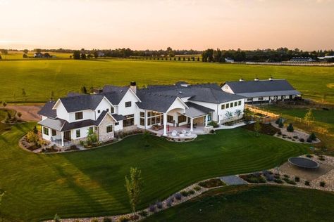 Aerial rear view of the house showcasing its expansive outdoor space and serene landscaping. Farm Dream House, House With Acreage, Luxury Homestead, Massive Farmhouse, Big Ranch House, Millionaire Houses, Farm Mansion, Acerage Homes, Farmhouse Mansion