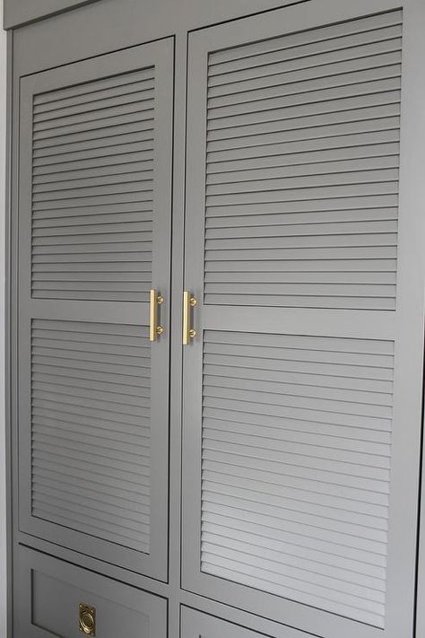 Charcoal gray laundry room features charcoal gray louvered cabinets adorned with brass handles built above stacked gray drawers adorned with vintage brass ring hardware. Mediterranean Laundry, Gray Beadboard, Gray Laundry Room, Beadboard Cabinets, Contemporary Laundry, Cottage Laundry, Contemporary Laundry Room, Landry Room, Herringbone Tiles