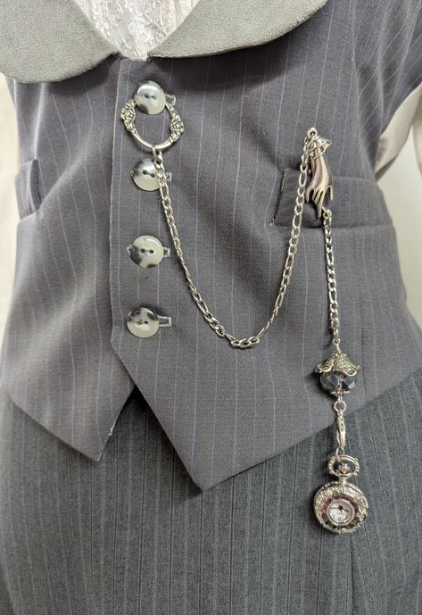 Vest chain for pocket watch  With or without 1" Working, Lightweight Mini Pocket Watch  Heavy stainless steel chain with button ring Fancy hand connector hides a small alligator clip - great for clipping onto a collar or vest pocket flap. Fob drop has large sparkly crystal and lobster clasp  Great addition to your wardrobe or costume.    Very Victorian and very cute! Small 1" watch with open center front and embossed back design. The watch face is white, as shown. Very good quality and design Wa Pocket Watch Fashion, Pocket Watch Chains, Watch Decoration Ideas, Pocket Watch Outfit, Buttons On Clothes, Sewing Chatelaine, Vest Chain, Victorian Pocket Watch, Victorian Watch