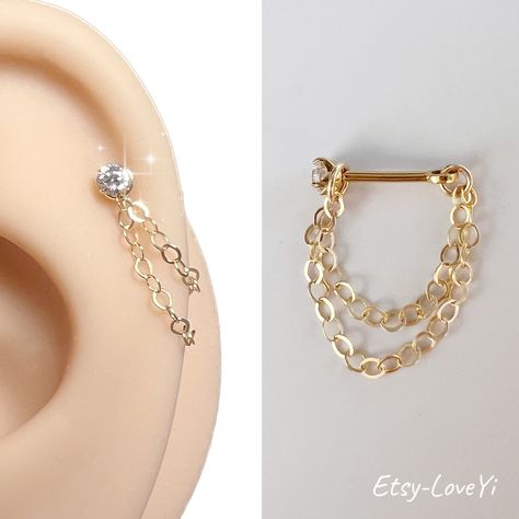 ♥Simply♥Dainty♥Everyday♥Minimal♥ 14k gold filled chains titanium barbell  CZ size: 2.5mm Post length: 6mm 20 gauge /0.8mm Chain lengths:  25mm and 30mm 30mm and 35mm Earrings are priced individually. Customer advisory note: Due to the size and texture of the ball (back), I would strongly advise wearing a latex glove when attaching the ball, and twist as tight as possible. Countless customers have dropped and lost the ball on their first attempt at attaching it.  --------------------------------- Gold Styled Ears, Elegant Ear Stack, Ear Scape, Piercing Chain, Helix Chain Earrings, Earring Chain, Gold Earring Stack, Earring Stacks, Double Helix Piercings