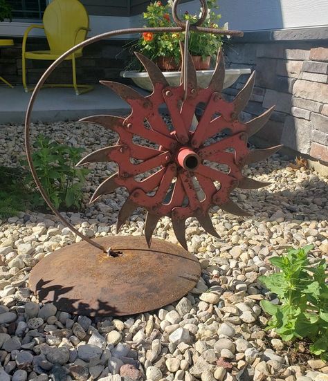 Repurposed farm yard art in 2022 | Metal yard art, Yard art, Outdoor metal art Yard Art Landscaping, Hay Rake Wheel Ideas, Repurposed Farm Items, Plow Disc Ideas, Brake Rotors Repurposed, Old Rake Head Ideas, Farm Equipment Decor, Simple Plant Hanger, Rusty Metal Garden Art