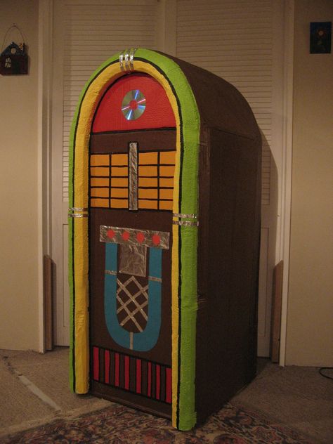 Jukebox stage prop made from large cardboard box. By Kitty Wake Juke Box Diy Cardboard, All Shook Up Musical Set, Diy Jukebox Prop Cardboard Boxes, Diy Jukebox Prop, Cardboard Props, Sock Hop Party, 60s Theme, Homecoming Floats, Large Cardboard Boxes