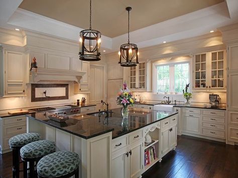 The white cabinets here are definitely elegant and when paired with the Uba Tuba granite they look even more so. The contrast of dark with light creates an eye-catching display from every angle. Ivory Kitchen Cabinets With Black Countertops, White Cabinets With Darker Countertops, Cream Cabinets With Dark Countertops, Dark Granite Kitchen, Cream Colored Kitchen Cabinets, Wyoming House, Affordable Kitchen Cabinets, Cream Kitchen Cabinets, Wood Countertops Kitchen