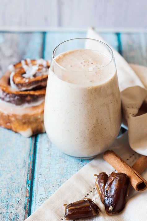 Banana Cinnamon Roll Smoothie with a cinnamon scroll, dates and cinnamon sticks in the background Cinnamon Roll Smoothie, Cinnamon Smoothie, Banana Smoothie Bowl, Kiwi Smoothie, Healthy Smoothie Recipes, Creamy Smoothies, Vitamix Recipes, Coconut Smoothie, Breakfast Drink