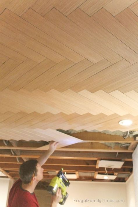 How to DIY: Wood Herringbone Pattern Basement Ceiling Idea | Can you believe this ceiling is actually a BUDGET DIY?! If you're looking for basement ceiling ideas we've got another here for you. This is a plywood ceiling and we've got the simple tutorial. Could be used to cover popcorn ceilings too! Part of our budget basement makeover. #howto #DIY #decor #ceiling #basement #basementideas #budgetdecor #frugalfamilytimes Herringbone Ceiling, Basement Remodeling Diy, Ceiling Diy, Plywood Ceiling, Basement Ceiling Ideas, Diy Basement, Sculptural Fashion, Basement Windows, Waterproofing Basement