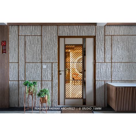 This door is a reflection of the contemporary style that runs throughout the space. As you enter, you'll be greeted with a sense of understated elegance and sophistication that is carried throughout the interior. Experience the beauty of this space for yourself. “Apartment Interior At Darshanam Clublife In Vadodara” Carpet Area: 2,300 Sq. Ft. Location: Gotri, Vadodara, Gujarat. Safety Door Design, Door Paneling, Prashant Parmar, Apartments Interior, Luxury Apartments Interior, Safety Door, Entry Wall, Main Door Design, Texture Paint