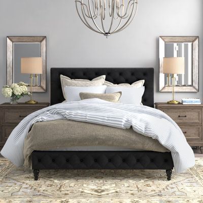 This standard bed includes classic accents that stand out and a low profile to make your bedroom appear larger. It's made from engineered wood, and it rests on turned front legs for a traditional touch. Wrapped in velvet for a luxe look, this bed also features a rectangular panel headboard with a scrolled top and button tufting. It's filled with foam for just the right amount of cushion as you enjoy your favorite show before bed. Nailhead trim rounds out this sleek design. Center slats support a Black Tufted Headboard Bedroom, Black Tufted Headboard, Black Headboard Bedroom, Black Upholstered Bed, Tufted Headboard Bedroom, Platform Bed Upholstered, Idea Bedroom, Lights Room, Decorations Lights