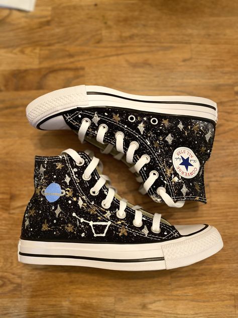 These galaxy converse use a cool splatter paint technique to get the cool galaxy look. then i carefully go over the splatter with the hand painted planets, stars and constellations. then to top off the shoes i spray them with spray on glitter just to give it the extra shine. THE PRICE OF THIS SHOE IS THE COST OF THE ORIGINAL SHOE PLUS $75 FOR THE WORK THAT GOES INTO IT. Space Shoes Aesthetic, Converse Decorated Diy, Painting On Converse, Drawn On Converse, Converse Painting Ideas, Converse Painting, Shoe Embroidered, Decorated Converse, Converse Ideas