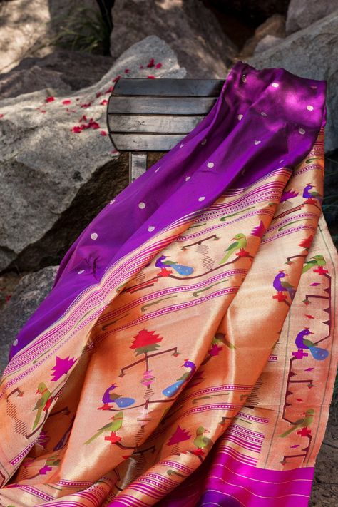 A stunning phlox purple Paithani saree in all its timeless glory!! The pretty gold zari buttas, the resplendent pink pallu with its gold tissue zari and the colourful floral, peacock and parrot motifs dazzle! A Paithani classic to be revered, the Paithani is perhaps the most difficult saree to weave, involving painstaking labour and high level of skill. The Akruti pattern seen on this saree is typically Paithani. The beauty of the Paithani is that it looks identical on both sides. Shop for our P Paithani Saree Colours, Paithani Saree Blouse Pattern, Paithani Motifs, Purple Paithani Saree, Pink Paithani Saree, Indian Frocks, Phulkari Saree, Sambalpuri Saree, Floral Peacock