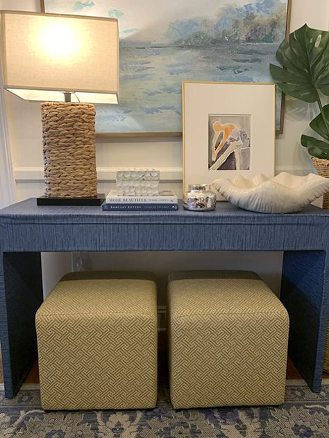 Entryway With Ottoman, Console Table With Ottomans Under Tv, Grasscloth Console Table, Console Table Under Tv, Storage Ottoman Coffee Table, Lake House Bedroom, Console Table Entryway, Living Room Pouf, Ottoman Decor