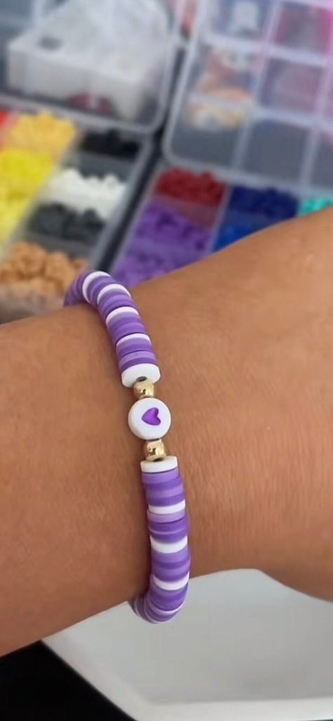 purple and white clay bead bracelet with love heart bead What To Make With Clay Beads, Clay Bracelet Idea, Purple Clay Bead Bracelet Ideas, Homemade Bracelets With Beads Ideas, Glass Seed Bead Bracelet Ideas, Clay Bead Jewelry Ideas, Purple Bracelet Ideas, Purple Clay Bead Bracelet, Clay Beads Ideas