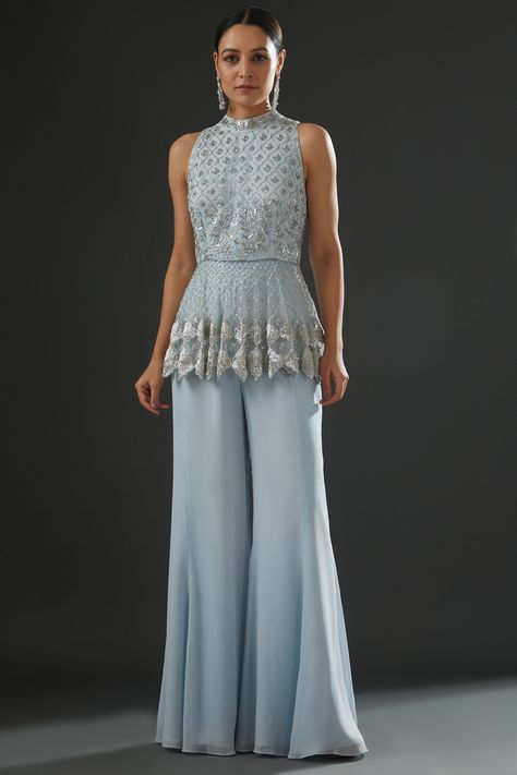 Featuring a powder blue peplum top in georgette and organza base with floral embroidery. It is paired with matching flared pants. . #perniaspopupshop #whatiworewastrending #ppuslove Indian Outfits Modern, Blue Peplum Top, Frock Designs, Boot Cut Pants, Indian Fashion Designers, Frock Design, Pernia Pop Up Shop, Flared Pants, Pant Set