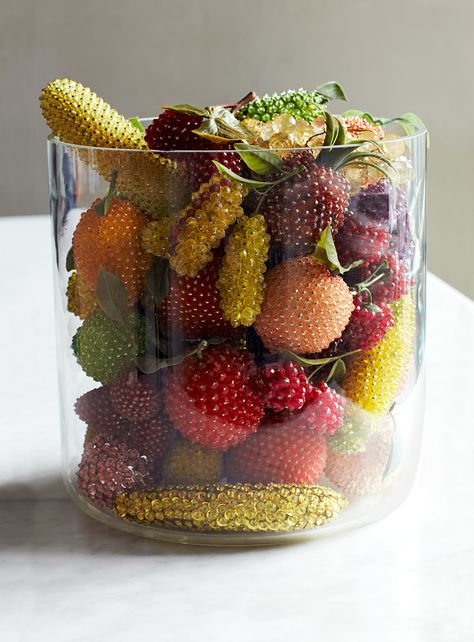 From the 1940s to the 1970s, fruit-making kits were all the rage for American makers. They came complete with Styrofoam bases, plastic beads or sequins, and pins for attaching them. “Some people took artistic license in trying to make them realistic -- a banana with green spots to look half-ripe, for example,” says Karch. “But others are just kitsch.” No matter the material, the rarest finds are slices, half-eaten pieces, and bunches of berries or grapes. Fake Fruit Decor Kitchen, Fake Fruit Decor, Tropical Wedding Decor, Fake Fruit, Artificial Fruit, Fruit Display, Fruit Displays, Wedding Beach Ceremony, Fruit Plate