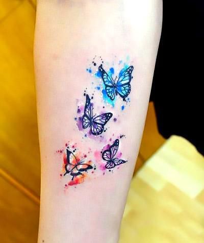 Watercolor small butterflies in two different shades. Drawn in purple, blue and orange. Paint Tattoo, Watercolor Butterfly Tattoo, Purple Butterfly Tattoo, Blue Butterfly Tattoo, Butterfly Tattoo On Shoulder, Simple Tattoos For Women, Small Butterfly Tattoo, Butterfly Tattoos For Women, Artist Tattoo