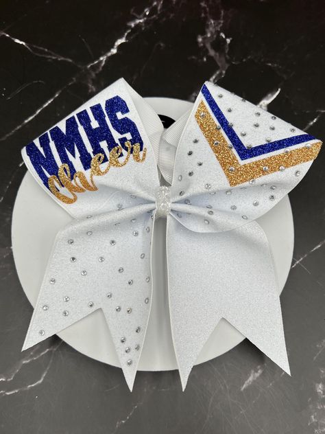 3" x 28" grosgrain ribbon with glitter heat transfer vinyl and ponytail elastic attached. Finished product 7" wide by 7" tall.  "Price per bow" All bows and masks are customizable: we can do it in your colors, with your team name/ mascot/logo/ Font in YOUR budget, Just message me for information on how to place your custom order.  Materials and fabrics can be substituted. We do not warranty hair elastics as they are n ot manufactured by us. All custom orders and bows with names/initials/monogram Cheer Bow Ideas, White Cheer Bows, Competition Cheer Bows, Coachella Party Theme, Cute Cheer Bows, Competition Bows, Coachella Party, Custom Cheer Bows, Glitter Cheer Bow