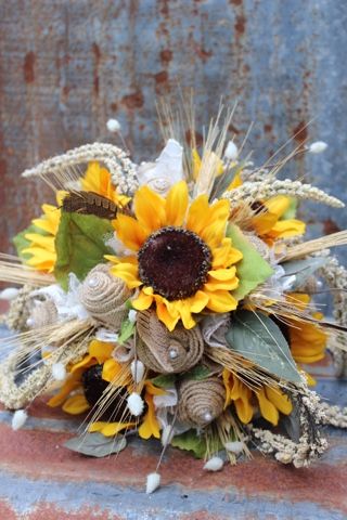 Sunflowers and burlap roses! Over the years, this has been a popular bouquet, although the original version had some wispy grass in it, which I can no longer get (I've looked for 2+ years). When this bride to be inquired about the bouquet and I told her I could do something similar without the grass, she replied "what about using dried wheat instead?" And we both love how it turned out! So going forward this bouquet can have dried wheat or wispy feathers in it, along with the burlap roses, su... Wedding Music List, Burlap Bouquet, Burlap And Lace Wedding, Rustic Sunflower Wedding, Burlap Roses, Dried Wheat, Sunflower Themed Wedding, Vintage Burlap, Wedding Engagement Pictures