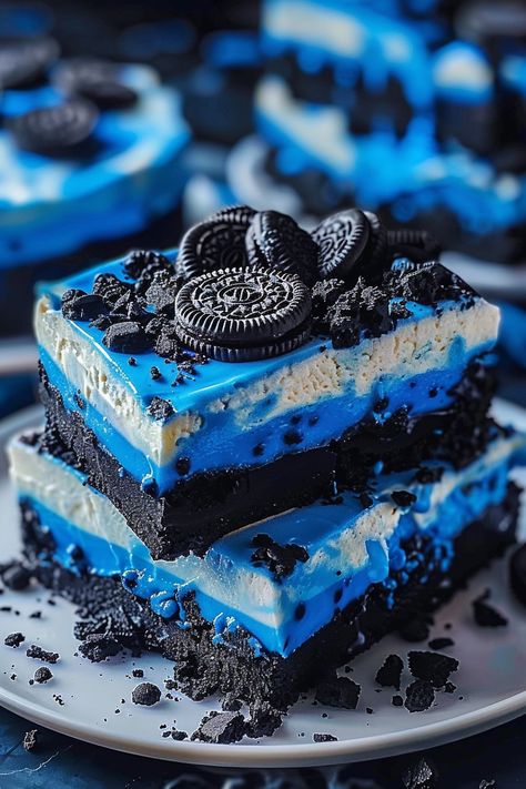 Ingredients: For the Blue Velvet Cake: 1 box blue velvet cake mix, 3 eggs, 1/2 cup vegetable oil, 1 cup buttermilk For the Oreo Cheesecake Layer: 16 oz cream cheese, 1/2 cup sugar, 2 eggs, 1 tsp vanilla extract, 1 cup crushed Oreo cookies For the Cream Cheese Frosting: 8 oz cream cheese, 1/2 cup butter, 4 cups powdered sugar, 1 tsp vanilla extract Additional: Whole Oreo cookies for decoration  Instructions: 1. Preheat oven to 350°F and grease a 9-inch springform pan. 2. Prepare the blue velvet cake batter according to package instructions and pour into the pan. 3. In a separate bowl, beat cream cheese and sugar until smooth. Add eggs and vanilla, mix well. Stir in crushed Oreos. 4. Pour the cheesecake mixture over the cake batter in the pan. Blue Cheesecake, Blue Velvet Cake, Cheesecake Mixture, Ultimate Chocolate Chip Cookies, Oreo Cheesecake Recipe, Blue Velvet Cakes, Crushed Oreo, Oreo Cheesecake Recipes, Ultimate Chocolate Chip Cookie