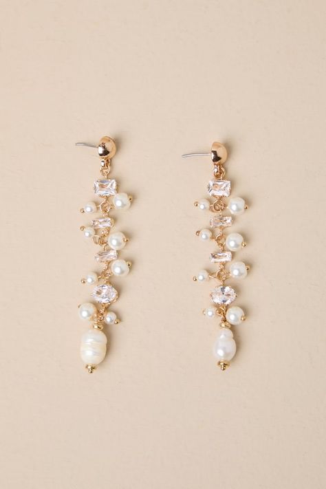 If you have an instinct for elegance, you need the Lulus Decadent Approach Gold Pearl Rhinestone Drop Earrings! Shiny, gold-toned metal shapes these stunning earrings that have a drop silhouette with various sizes and cuts of rhinestones (along with luminous faux pearls) strung across their length. Post backs. 3" Long. 40% Iron, 40% Plastic, 20% Pearl. Imported. Lulus | Decadent Approach Gold Pearl Rhinestone Drop Earrings. Champagne Drop Earrings, Light Yellow Earrings, Opal Wedding Earrings, Hoco Earrings, Hoco Jewelry, Wedding Earrings Bride, Pearl Wedding Accessories, Hoco Inspo, Rose Gold Bridal Jewelry