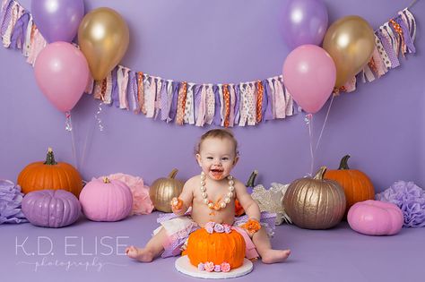 Pumpkin themed cake smash session in pink, gold, purple and orange. www.kdelise.com Pumpkin Smash Cake 1st Birthdays, Pumpkin Themed Cake, Pumpkin Smash Cake, Themed Cake Smash, Pumpkin Patch Birthday, Fall 1st Birthdays, Pumpkin Pie Cake, Halloween First Birthday, Halloween 1st Birthdays