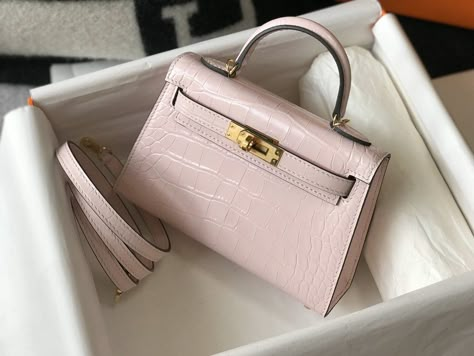 Description HRMS Mini Kelly 19 Embossed Patent Pink Matte Bag With Gold-Toned Harware For Women, Handbags, Shoulder Bags 7.5in/19cm Rep 1:1 Size: 19 x 15 x 16 cm / 7.5 x 6 x 6.2 inches (Length x Height x Width) Dating back to 1989, this rare dainty-sized Hermès Kelly is a much-coveted vintage piece unmatched in elegance. The petite bag is in a good vintage shape. Hermès bags are considered the ultimate luxury item worldwide. Each piece is handcrafted with waitlists that can exceed a year or more. Pink Mini compartment Gold-toned hardware Interior with 1 side zippered pocket A protective footed bottom Handle: Single Adjustable shoulder strap Includes box, dust bag. This product is of the best quality. The production time is 15-20 working days. If you want to custom your own bag, please cont Mini Kelly, Luxury Bags Collection, Hermes Kelly Bag, Kelly Bag, Fancy Bags, Hermes Bags, Pink Mini, Evening Clutch Bag, Hermes Bag