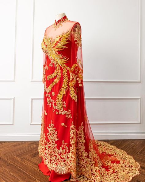 Red and gold ✨ This stunning red and gold ao dai with a captivating phoenix accent, that totally steals the show, has us swooning. The blend of traditional elements and modern details marry beautifully together to create a vision in red and gold. The gold lace runs throughout as a striking motif adding elegance and romance to the look. Shine bright in this gorgeous gown which features in our new collection! Shop via the link in bio. #dreamdresses #dreamdressesbypmn #modernweddingdress ... Gold Ao Dai, Bridal Ao Dai, Phoenix Embroidery, Ao Dai Vietnamese, Modern Bridal Dress, Dream Dresses, Illusion Neckline, Modern Bridal, Modern Wedding Dress