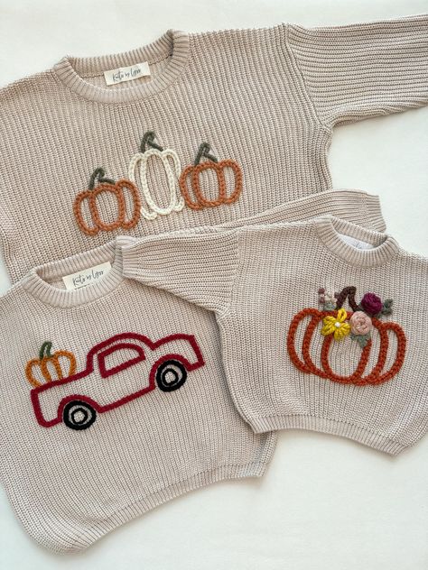 Custom Hand Embroidered Sweaters for Fall and Halloween. Photos are examples of sweaters made in the past and designs can be customized. If you have a specific fall/halloween design, send me a message and we can chat about what you're looking for.  MATERIALS/FIT: This set of hand embroidered sweaters are completely customizable and come in different colors. These sweaters have an oversized fit/feel and are a knit material, so they do have a stretch to them. See approximate measurements below:  Size/Length/Chest      * 0-3 M / 11 in / 12 in     * 3-6 M / 11.5 in / 13 in     * 6-9 M / 12 in / 13.75 in     * 9-12 M / 13 in / 14.5 in     * 12-18 M / 14.25 in / 15.5 in     * 2T / 15.5 in / 16 in     * 3T / 16.5 in / 17 in     * 4T / 17.75 in / 17.75 in     * 5T / 19 in / 18.5 in EMBROIDERY:  En Fall Hand Embroidery Designs, Fall Sweater Embroidery, Embroidery On Sweaters, Hand Embroidery Sweater, Embroidered Sweater Diy, Embroidered Name Sweater, Baby Name Sweater, Hand Embroidered Sweater, Jumper Ideas