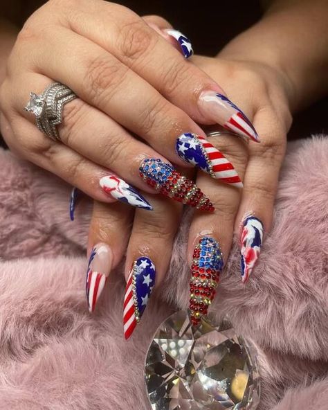 These nails are fearless and striking, boasting elaborate designs adorned with sparkling rhinestones and detailed striping reminiscent of the American flag. With their vibrant hues and three-dimensional artistry, they demand attention, making them an ideal choice for showcasing patriotism and embracing daring fashion. Nails For 4th Of July, American Flag Nails, African American Flag, Flag Nails, Patriotic Nails, Usa Nails, Dimensional Art, Patriotic Art, Glitter Gel Polish