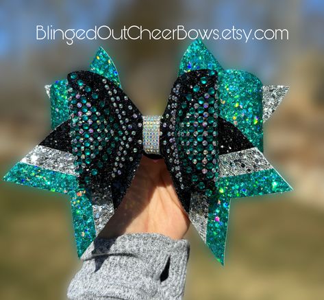 "follow us on tiktok @blingedoutcheerbows to see brand new bow styles first! Price per bow is $22   These bows are not discounted further for team orders  rhinestone cheer bow// teal Rhinestone cheer bow//competition cheer bow//bling bow//team colors//customizable bows// teal and black cheer bow with rhinestones like us on facebook \"blinged out cheer bows\"" Bow Styles, Competition Cheer, Cheer Tryouts, Varsity Cheer, Bling Bows, Cheer Stuff, Competitive Cheer, Cheer Squad, Custom Bows