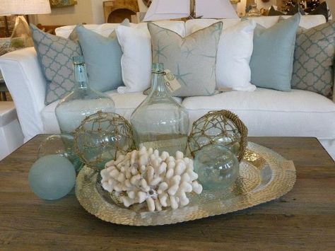 Love the coastal look! Coastal Arrangements Interior Design, Sea Living Room Decor, Coastal Tray Decor Ideas, Coastal Coffee Table Decor Ideas, Coastal Coffee Table Decor, Colored Couch, Coastal Living Room Decor, Coastal Living Decor, Coastal Lamp