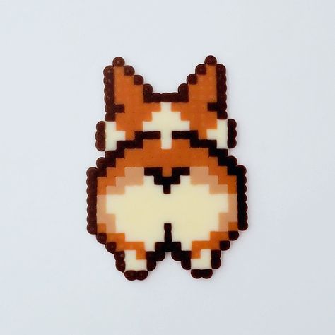 This handmade perler keychain or magnet celebrates the adorable charm of Corgi butts! This quirky and fun accessory is perfect for dog lovers and Corgi enthusiasts alike. Each piece is meticulously crafted with high-quality Perler beads, capturing the cuteness and character of a Corgi's derriere. Whether you choose to use it as a keychain or magnet, this Corgi Butt accessory is guaranteed to bring a smile to your face. *Dimensions (without keychain): 2 5/8H x 1 7/8W in *Made with high quality Perler and Artkal beads.  *Keychain materials: Durable, silver-toned nickel metal PLEASE NOTE: *Items will be ready to ship in 3-5 business days. *Due to different camera and screen display resolutions, colors may vary slightly from what you see in the listing. *All of my items are handmade and made t Perler Keychain, Face Dimensions, Beads Keychain, Perler Ideas, Corgi Butts, Mermaid Pendant, Grand Prairie, Keychain Cute, Nickel Metal