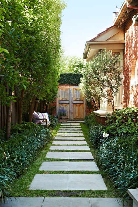 Melinda and Simon landscaped the garden themselves. The teak doors were picked up in Java while on a furniture-buying trip. “We knew they would make a fabulous feature in our garden,” says Melinda. “It was well worth the effort to get them here.” Courtyard Landscaping, Side Yard Landscaping, Pathway Landscaping, Side Yards, Desain Lanskap, Side Garden, Garden Pathway, Front Yard Garden, Side Yard