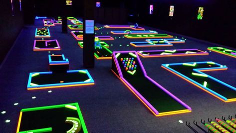 This glow in the dark mini-golf course is the perfect indoor attraction for all ages. Crazy Golf Ideas, Black Light Mini Golf, Indoor Foam Pit, Glow In The Dark Mini Golf, Mini Golf Course Ideas, Diy Mini Golf Course Ideas, Indoor Putt Putt, Golf Bar, Indoor Mini Golf