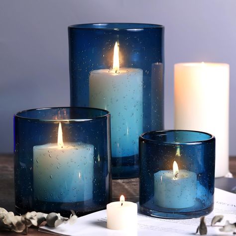 PRICES MAY VARY. Blue Hurricane Candle Holder: Blue Hurricane Candle holders has small bubbles on the surface, making it a light and ethereal appearance, just like surrounded by bubbles. When lit, Candlelight is irradiated on the bubbles through blue glass, creating a delicate and luxurious feeling. In addition, it can be used as a home decoration. Size: NITIME hurricane candle holders set consists of 3 blue candle holders of different sizes: 8*5.1inch, 4.7*4.7inch, 3.5*3.5inch. Suitable for Pil Navy Blue Mason Jar Centerpieces, Starry Night Tables, Shell Centerpieces Table Decorations, Wedding Dark Blue, Table Centerpieces Home, Pillar Candles Wedding, Shell Centerpieces, Blue Candle Holders, Blue Wedding Centerpieces