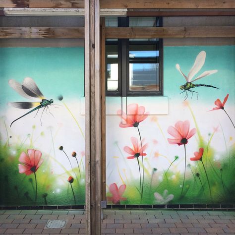 Garden Mural painted in a hospital outdoor area by Graffiti Artist Peaceful Progress based in Cardiff. Featuring Dragon Flies and field flowers. All in free hand spray paint. #Gardendesign #gardenmural #gardenart #graffitiwall #graffitimural #streetart #poppyart #dragonflyart #dragonfly #art Hand Spray, Garden Mural, Flower Mural, Sidewalk Chalk Art, Dragon Flies, Sidewalk Art, Field Flowers, Poppy Art, Fence Art