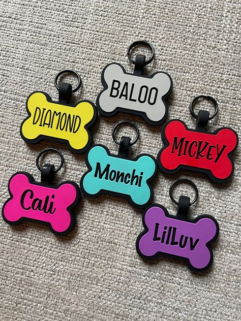 Made from high-quality silicone & customized with your dogs information. These are made of silicone, so they are quiet and don't jingle on the dog collar. The dog tag can have up to 3 lines on the front and back. Measures 1.5 inches in width and 1.25 inches in height. Includes titanium black keychain ring 13 COLORS TO CHOOSE FROM (all engrave black unless otherwise noted) - Aqua - Gray - Hot Pink - Light Blue (engraves a darker blue shade) - Light Pink (engraves a darker pink shade) - Light Purp Drukarka 3d, Black Keychain, 3d Printing Diy, Pink Border, Keychain Ring, Custom Dog Tags, Dog Information, Dog Bone, Pet Id Tags