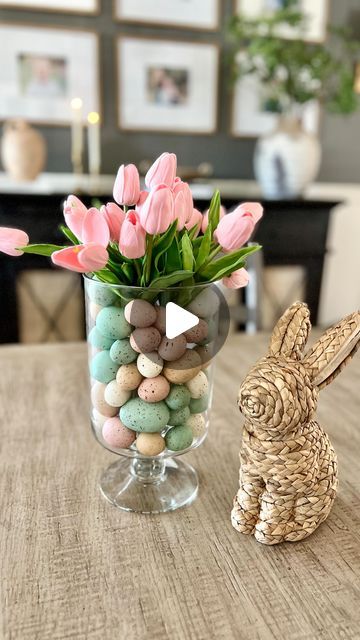 Nicole Chatham • Home Decor on Instagram: "Easy DIY Easter vase!  Comment SHOP for links to everything I used here! 🌷 

This glass hurricane is so perfect for creating different centerpieces year round!  The quality is so good and the price is 👌. I used my favorite Amazon tulips in pink 💗 and paired them with these pretty speckled Easter eggs. And how cute is this little rattan bunny? 🐰 

Have you started putting out any Easter decor yet?  I can’t believe it’s only a month away! 

FOLLOW @life.on.chatham.lane for more styling ideas ✨

TO SHOP THIS POST:

✨Comment SHOP for a direct link to be sent to your DMs

✨Click on the link in my bio “Shop my home and favs”

✨✨Direct link to shop: https://liketk.it/4yLhs✨✨

#neutralhome #ltkhome #cozyhome #homedecor #interiordesign #affordabledecor Easter Vase, Easter Centerpieces Diy, Tulips In Vase, Plastic Eggs, Easter Centerpieces, Affordable Decor, Transitional House, Diy Vase, Diy Easter