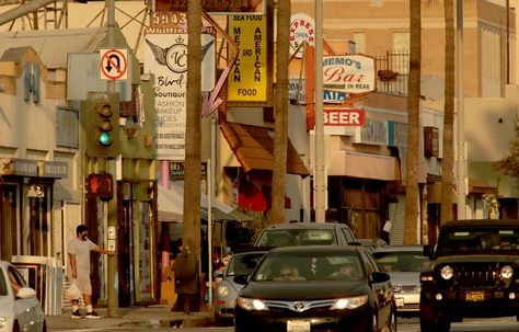 Small shops and restaurants line Whittier Boulevard in East Los Angeles. La In The 90s, Los Angeles Painting, La Painting, Chicano Movement, 90s City, 90s Los Angeles, Angeles Aesthetic, Ventura Boulevard, Los Angeles Aesthetic